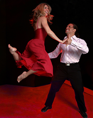 Patty In a red dress in a lift with dance partner (prob 2003)